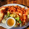 Grilled lobster with pasta and mixed vegetables at Restaurant Villa Ortegas.