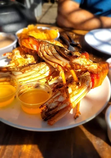 Grilled shrimp and lobster at Restaurant Villa Ortegas, served with various dipping sauces.