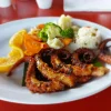 Grilled octopus dinner at Restaurant Villa Ortegas, served with rice and mixed vegetables.